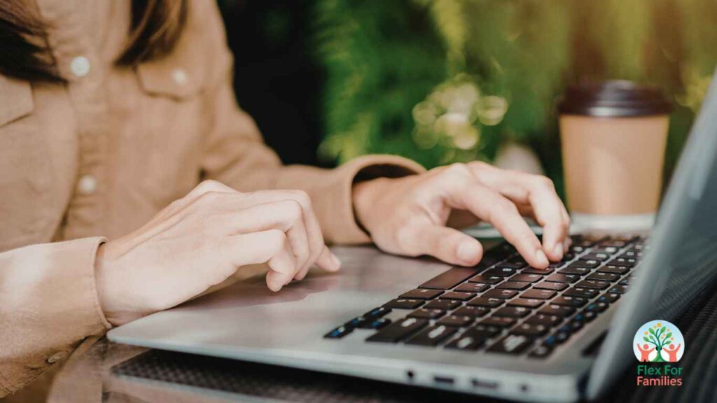 Mom writing a blog post on a laptop at home